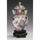 A Japanese Fukagawa Imari porcelain vase and cover, Meiji period, painted with panels of flowers,