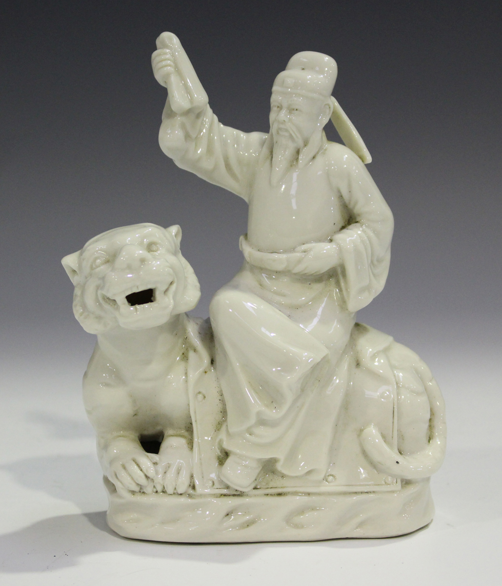 A Chinese blanc-de-Chine figure group, 20th century, modelled as an immortal seated on the back of a
