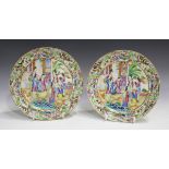 A pair of Chinese Canton famille rose porcelain plates, mid-19th century, each painted with a