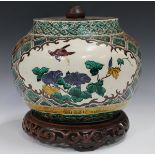 A Japanese Kutani jar, probably Edo period, of stout circular form, enamelled in green, aubergine,