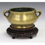 A Chinese polished bronze bombé censer, mark of Xuande but probably late Qing dynasty, the