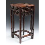 A pair of Chinese hardwood graduated occasional tables, late Qing dynasty, each square panelled