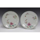 A pair of Chinese famille rose export porcelain plates, Yongzheng/Qianlong period, each painted with