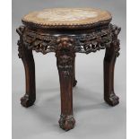 A Chinese hardwood stand, early 20th century, the top inset with a rouge marble panel within a