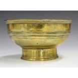 A Chinese polished bronze circular footed bowl, Qing dynasty, the body with horizontal ribbed girdle