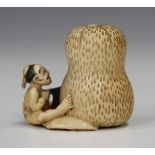 A Japanese carved ivory netsuke, Meiji/Taisho period, modelled as a seated gentleman sawing a