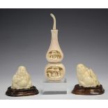 Two Japanese ivory okimono carvings, early 20th century, each modelled as a seated Hotei, incised