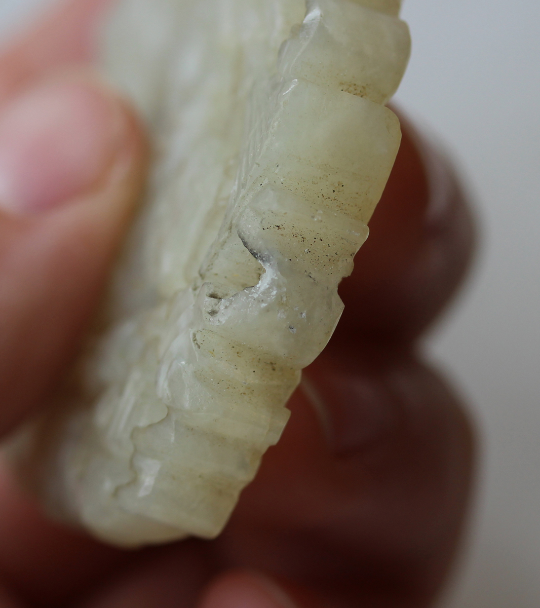 A Chinese pale celadon jade pendant, probably late Qing dynasty, carved and pierced to each side - Image 4 of 10