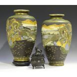 A pair of Japanese Satsuma earthenware vases, 20th century, each painted and gilt with arhats in