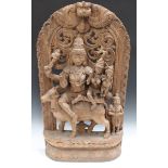 An Indian carved and pierced hardwood panel, 20th century, modelled with Shiva, Parvati and Ganesh