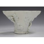 A Chinese blanc-de-Chine porcelain libation cup, probably Kangxi period, of traditional horn form,