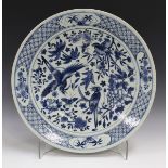 A Chinese blue and white porcelain circular dish, late 19th century, painted with magpies amidst