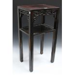 A Chinese hardwood stand, late Qing dynasty, the rectangular panelled top above a pierced scroll