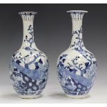 A pair of Chinese blue and white porcelain bottle vases, late 19th century, each ovoid body and