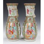 A pair of Chinese Canton famille rose porcelain vases, mid to late 19th century, each typically
