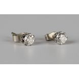 A pair of diamond single stone earstuds, each claw set with a circular cut diamond, with post and