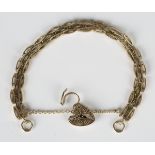 A 9ct gold decorated oval link bracelet on a 9ct gold heart shaped padlock clasp, length 18cm.