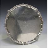 A George V silver salver with gadrooned rim and engraved crest, on claw and ball feet, Sheffield