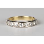 A gold and diamond nine stone half-hoop eternity ring, mounted with a row of circular cut