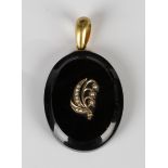 A Victorian gold mounted oval black onyx pendant mourning locket, the front with a seed pearl set