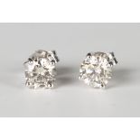 A pair of white gold and diamond single stone earstuds, each claw set with a circular cut diamond,