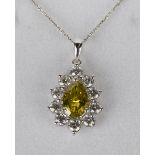 A platinum, colour enhanced dark fancy yellow diamond and diamond pendant, claw set with a pear