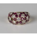 A gold, ruby and diamond bombé ring, mounted with circular cut rubies and diamonds in a floral
