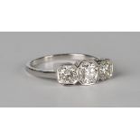 A platinum and diamond three stone ring, mounted with circular cut diamonds in octagonal settings