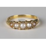 A gold ring, mounted with a row of five graduated half-pearls and four pairs of rose cut diamonds at