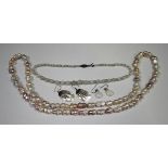 A single row necklace of graduated opal beads with faceted divisions at intervals, on a silver and