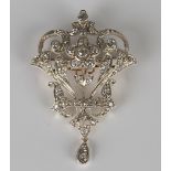 A diamond brooch in a scroll pierced design, mounted with cushion cut diamonds, the front with a