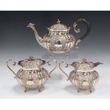 An Indian white metal three-piece tea set, comprising teapot, sugar bowl and cover and milk jug