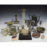 A collection of assorted plated items, including a chamberstick and a glass claret jug.Buyer’s