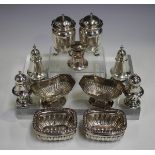 A group of assorted silver condiments, including a pair of George V pepper casters, Birmingham 1913,