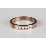 A 9ct rose gold and diamond half eternity ring, mounted with a row of eight circular cut diamonds,