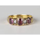 A 9ct gold, garnet and half-pearl ring, mounted with three cushion cut garnets alternating with