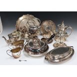 A collection of assorted plated items, including a circular entrée dish and cover with ebonized