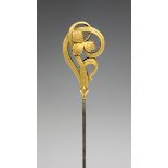 A French gold topped stickpin, circa 1910, in an Art Nouveau floral design, length of top 3.5cm.