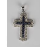 A 9ct white gold, sapphire and diamond pendant, designed as a cross, mounted with a row of