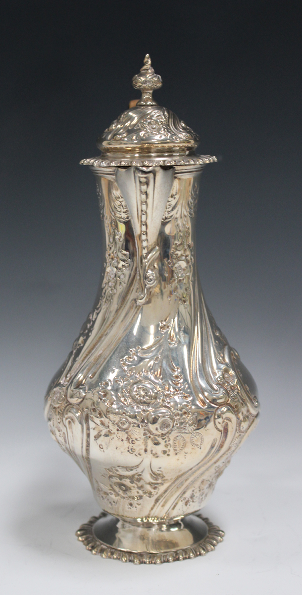 A late Victorian silver hot water jug of baluster form with domed hinged lid and finial, decorated - Image 4 of 4