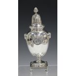 A George V Classical Revival silver sugar caster with pierced domed cover and pineapple finial,