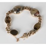 A gold and vari-coloured oval agate curblink bracelet on an oval clasp, detailed '9ct', fitted