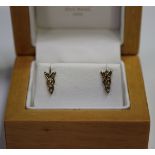 A pair of 9ct gold earstuds of pierced Celtic design, with post fittings and associated butterfly