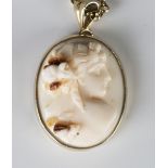 A gold mounted oval shell cameo pendant, carved as a portrait of a lady, length 4cm, with a circular