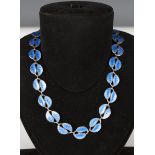 A Norwegian silver and pale blue enamelled necklace by David Andersen, the links in a twin leaf