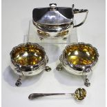 A pair of George II silver circular salts, each with scalloped rim and gilt interior, on scallop