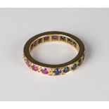 A gold, synthetic ruby and synthetic sapphire eternity ring, ring size approx M, with a case.Buyer’s