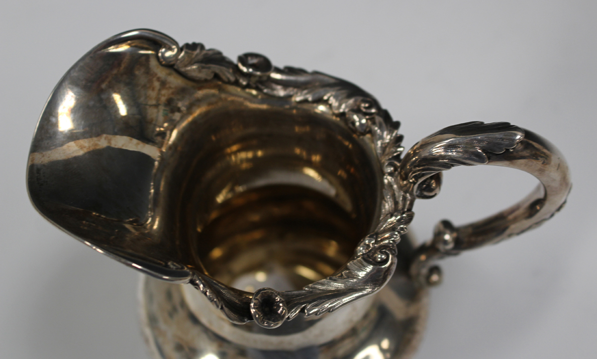 A William IV silver milk jug with floral and foliate cast rim, foliate capped scroll handle, and - Image 3 of 3