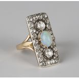 A gold, opal and diamond panel shaped ring, the centre claw set with an oval opal between two