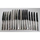 A set of eight Elizabeth II silver handled and steel bladed table knives and eight matching